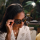 A DJ presses the video trigger button on a pair of Ray-Ban Stories smart glasses.